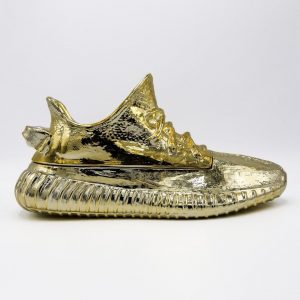 @ceezemc has dropped his first Sneaker Sculpture. This Gold Adidas Yeezy 350 scu...